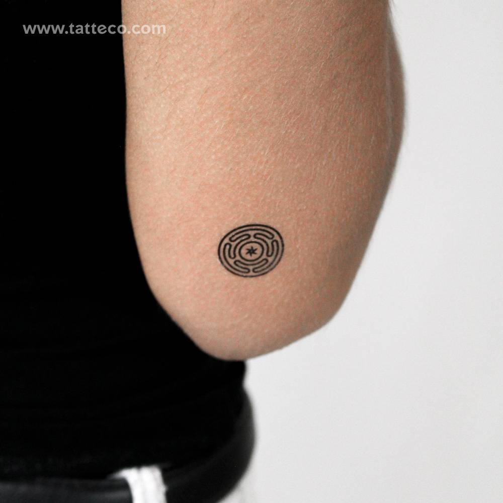 Hecate’s wheel temporary tattoo located on the tricep.
