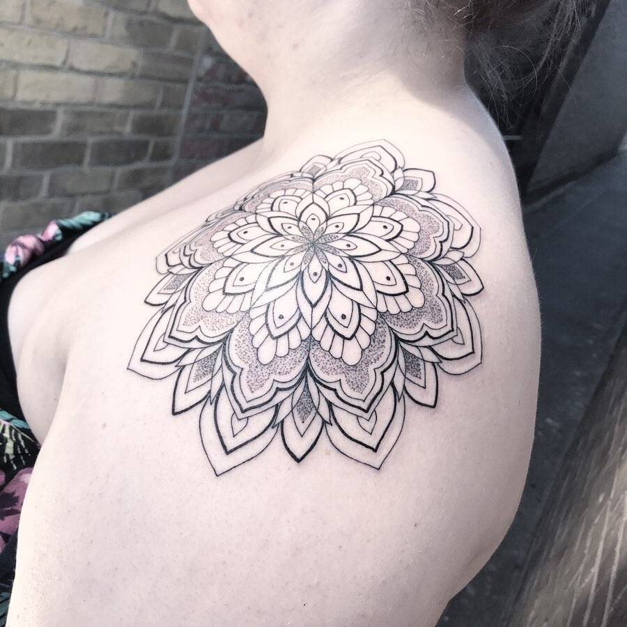Mandala tattoo on the shoulder.