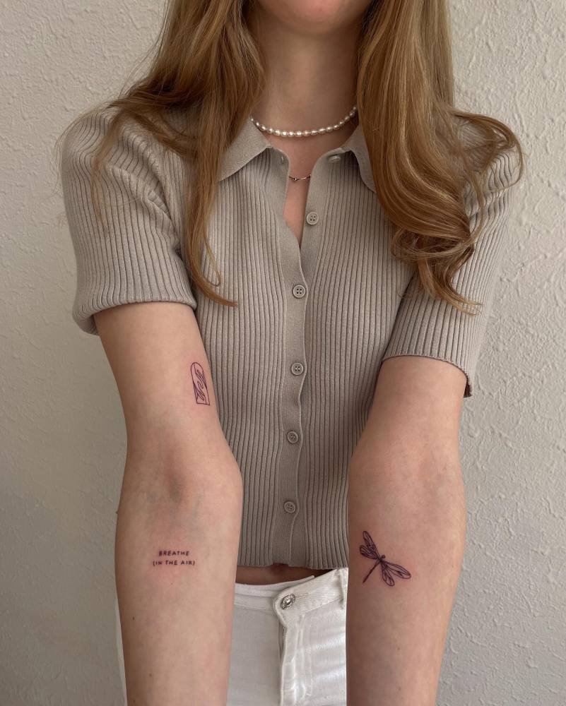 Holding hands, "breathe" and dragonfly tattoos.