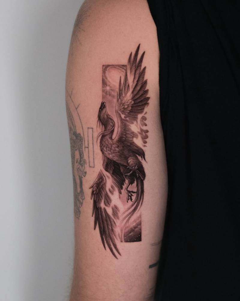 Phoenix tattoo in micro-realistic style located on the tricep.