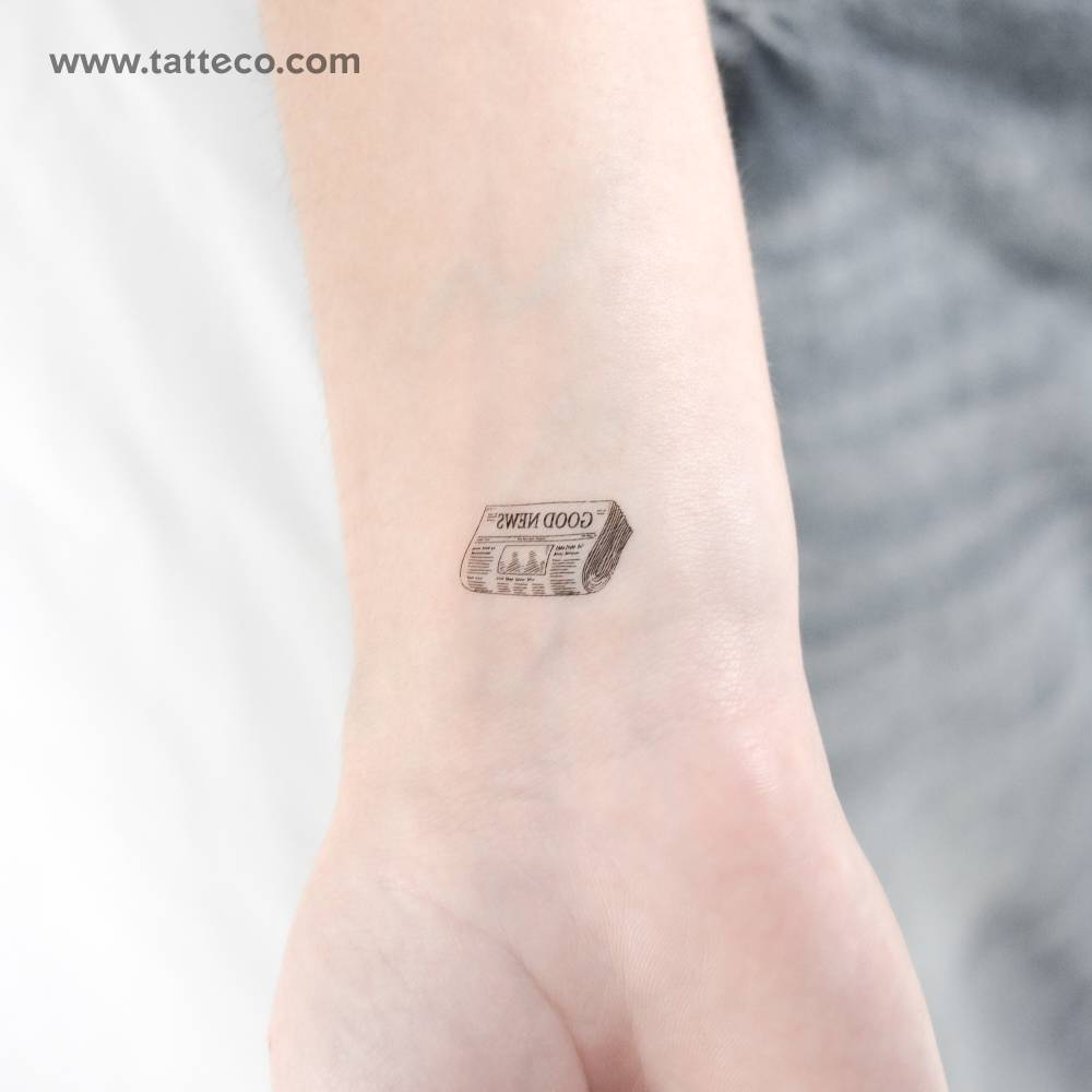 Newspaper temporary tattoo located on the wrist.