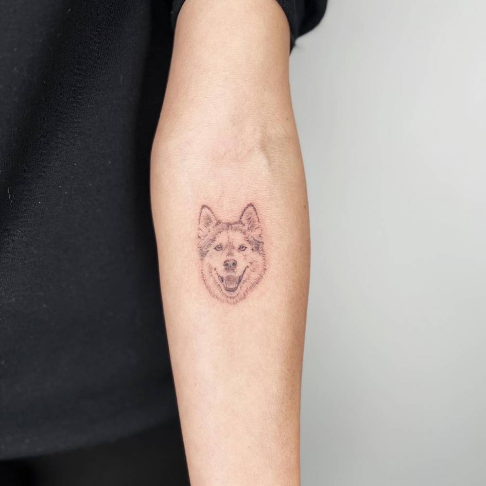Micro-realistic Husky portrait tattoo located on the inner forearm.