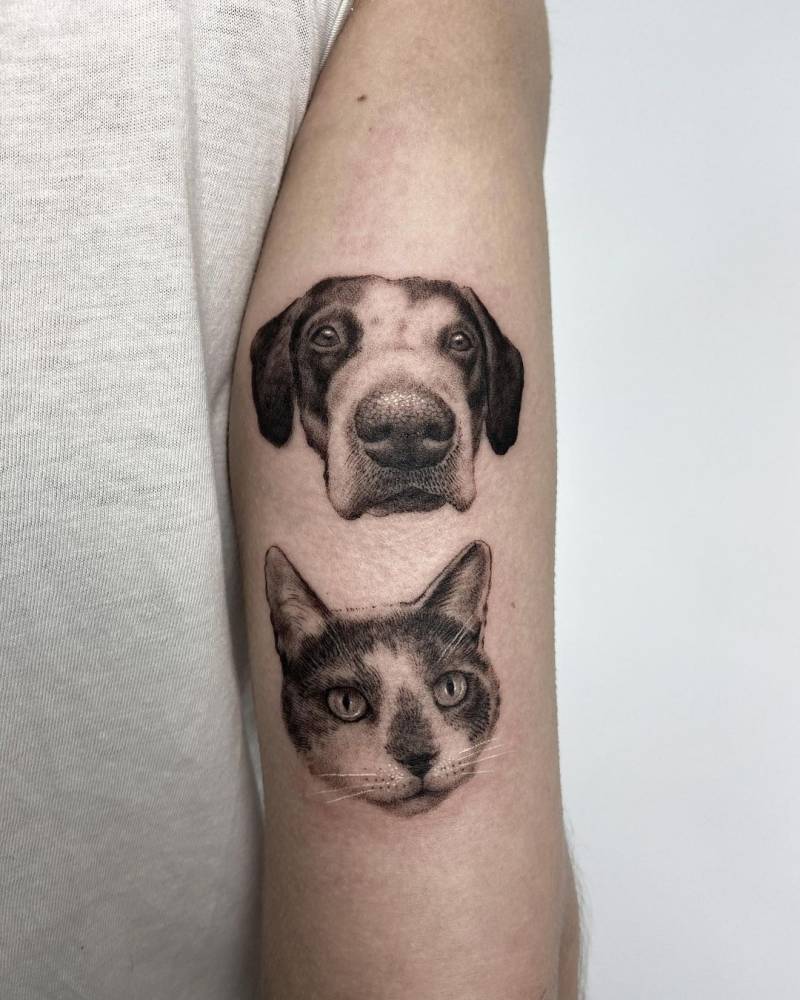 Micro realistic cat and dog portrait tattoo on the tricep.