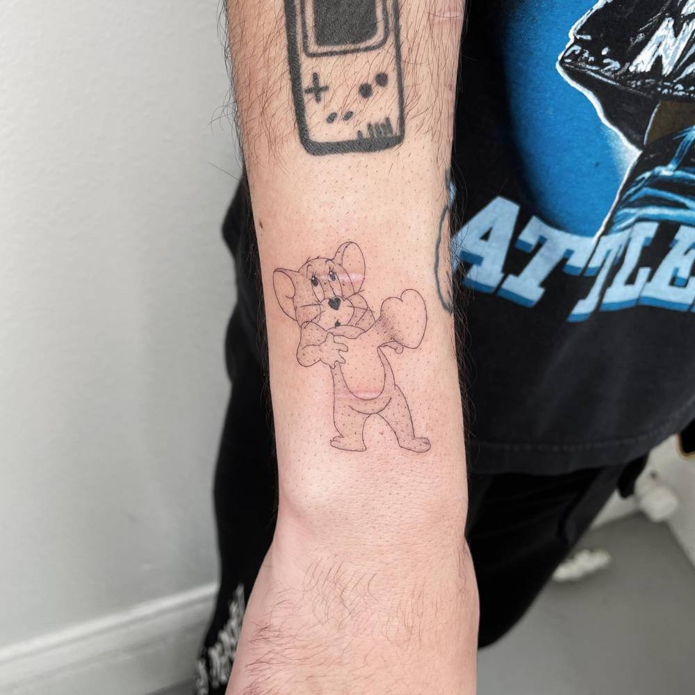 Jerry tattoo located on the wrist, cartoon style.