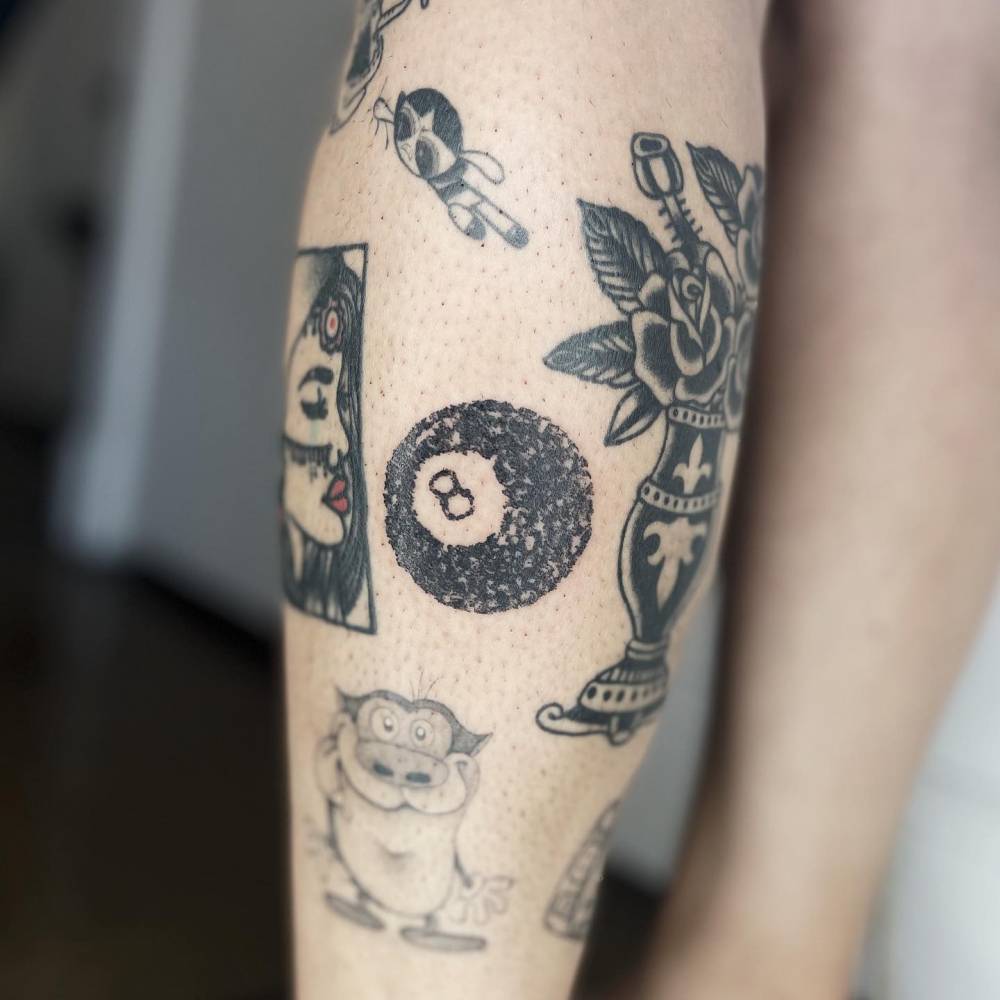 Crayon textured Eight-ball tattoo located on the calf.