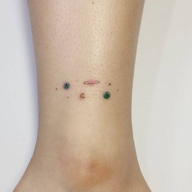 Minimalistic galaxy tattoo located on the ankle.