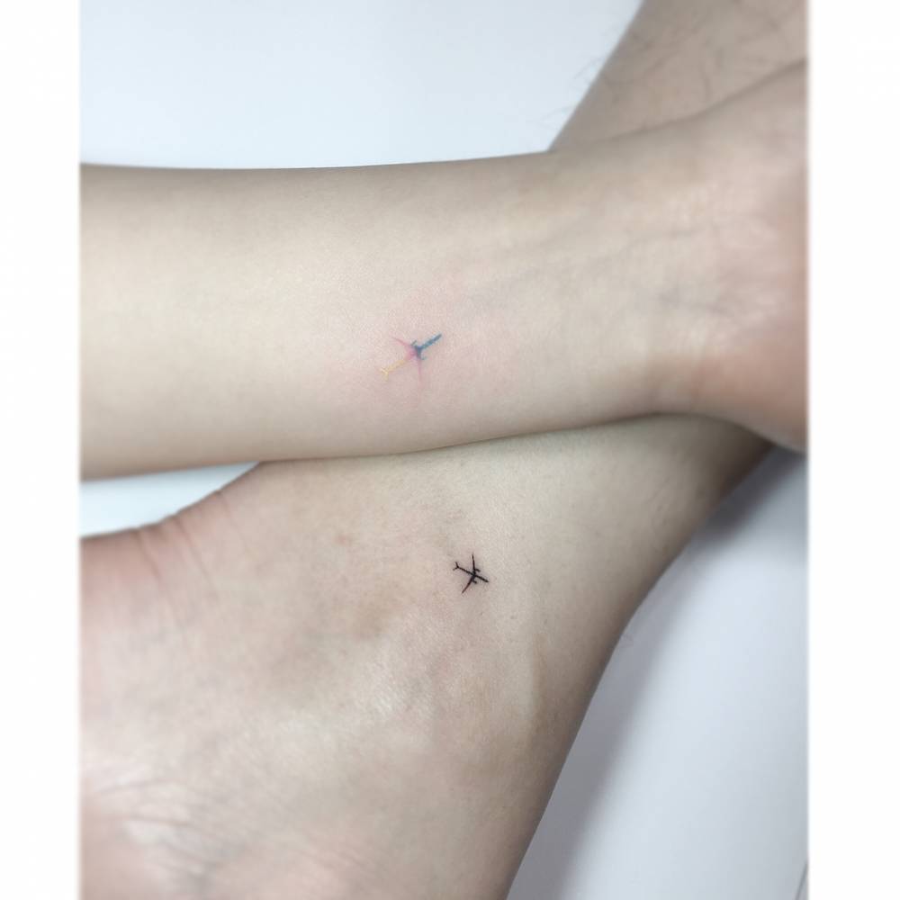 Matching planes tattooed for best friends.