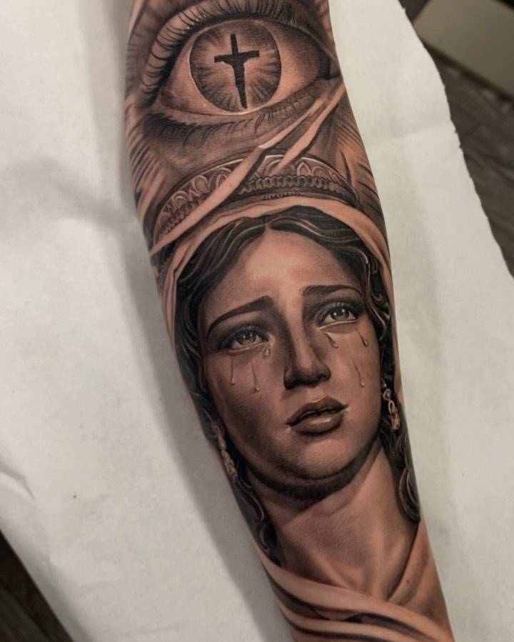 Black and grey Our Lady of Sorrows tattoo located on the inner forearm.