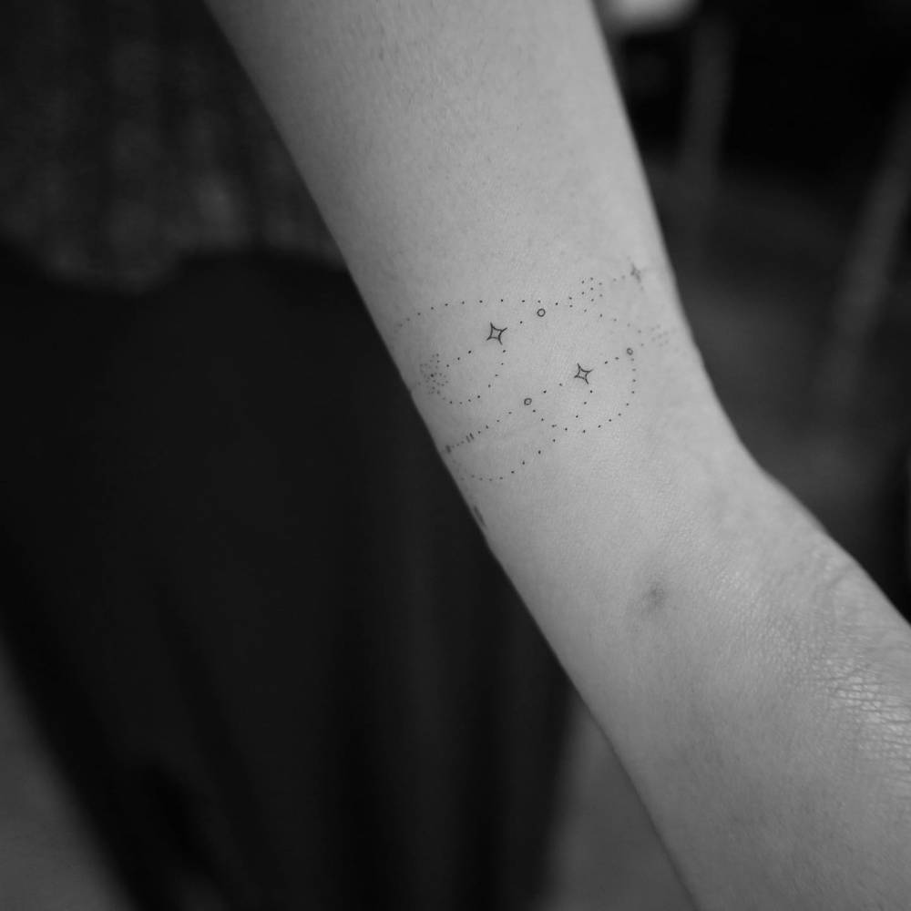 Ornamental wristband tattoo done in fine line.