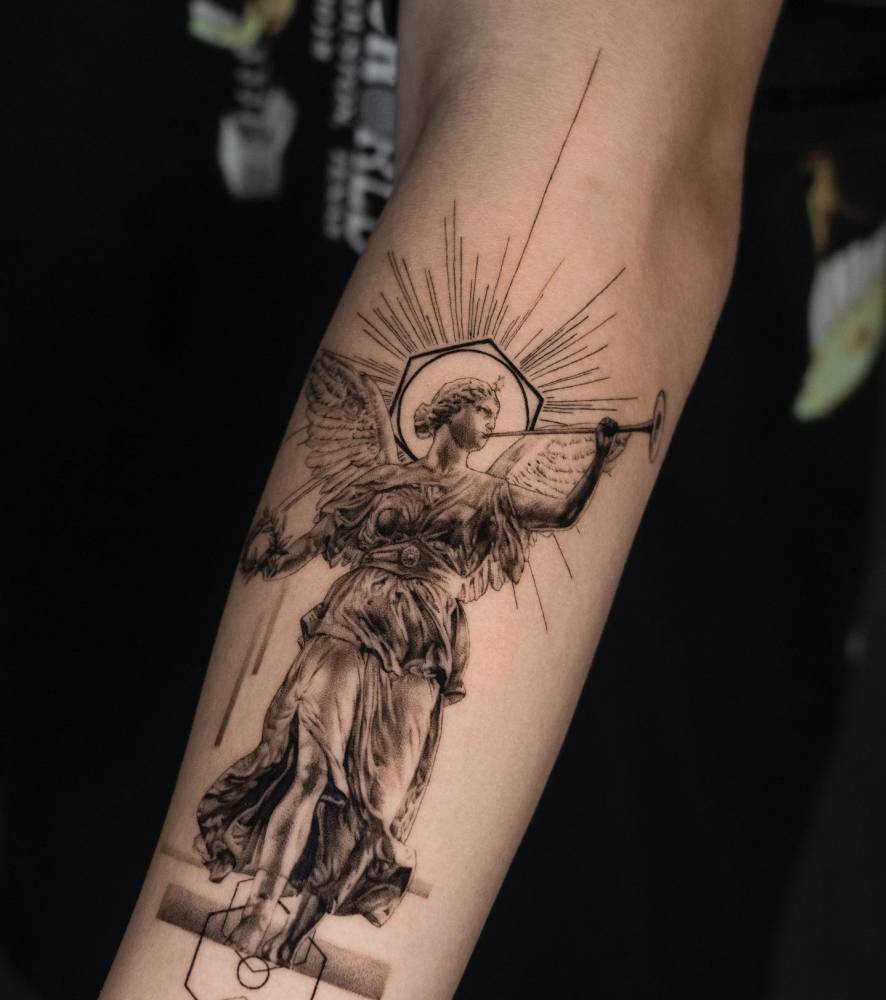 Micro-realistic style Nike tattoo located on the forearm.