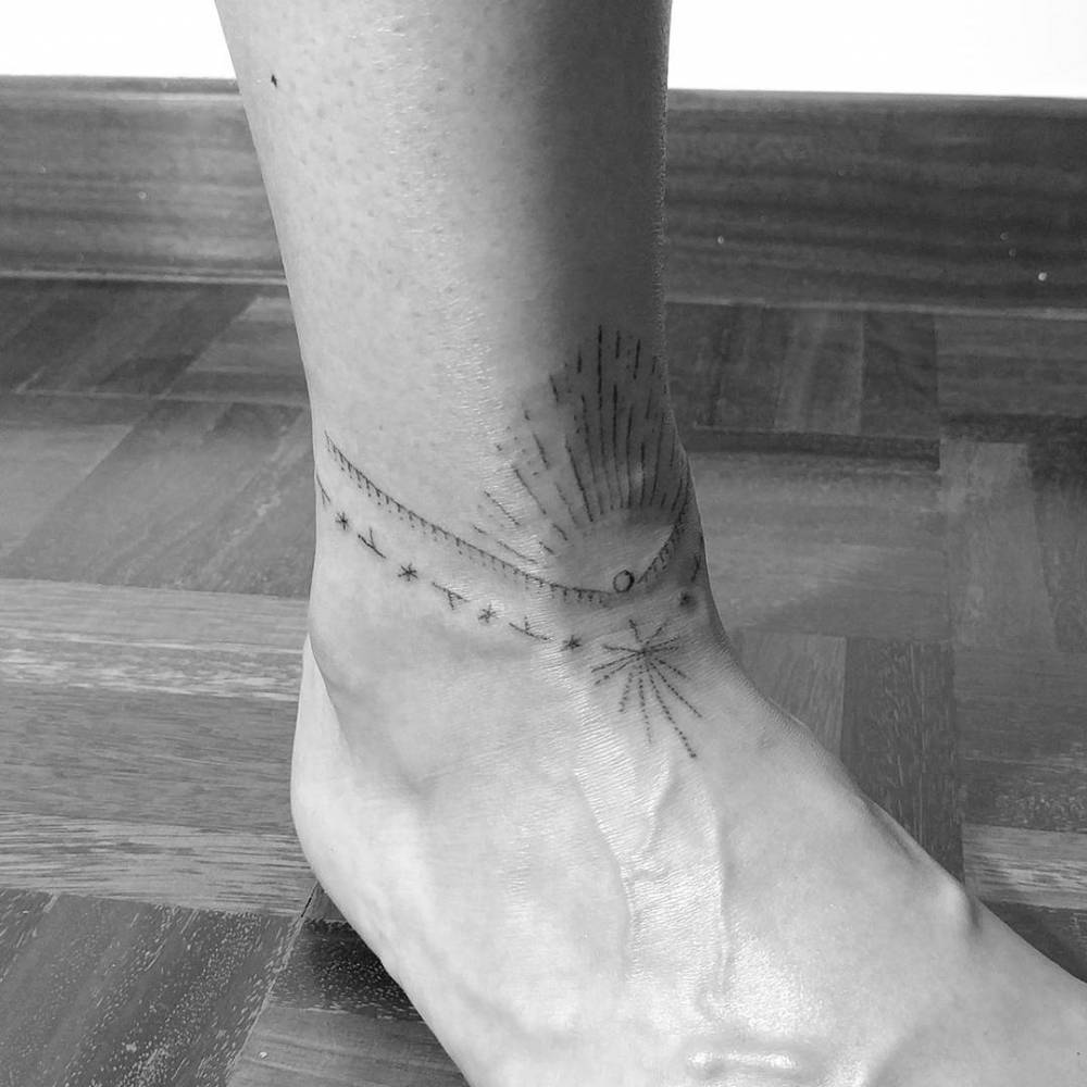 Hand poke ornamental anklet tattoo.