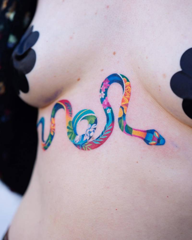 Colorful floral snake tattoo done in watercolor style.