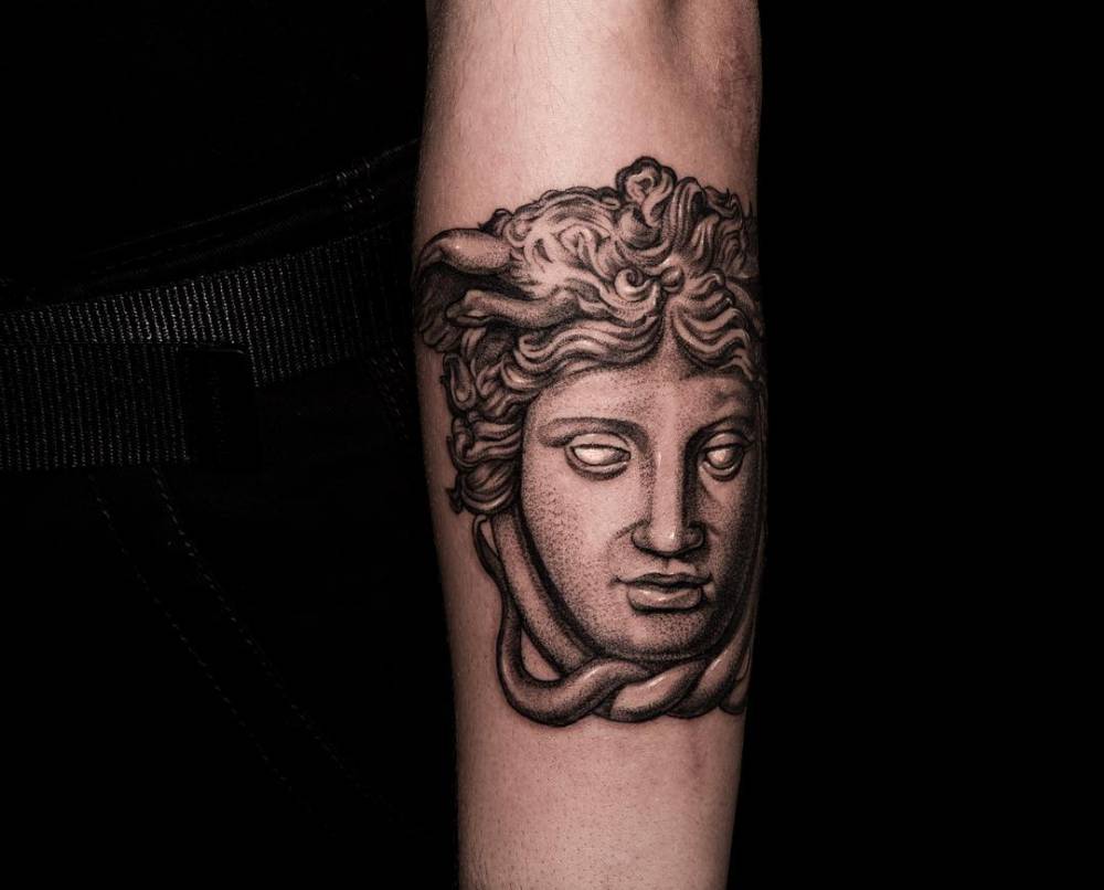 Black and grey Medusa Rondanini tattoo located on the bicep.