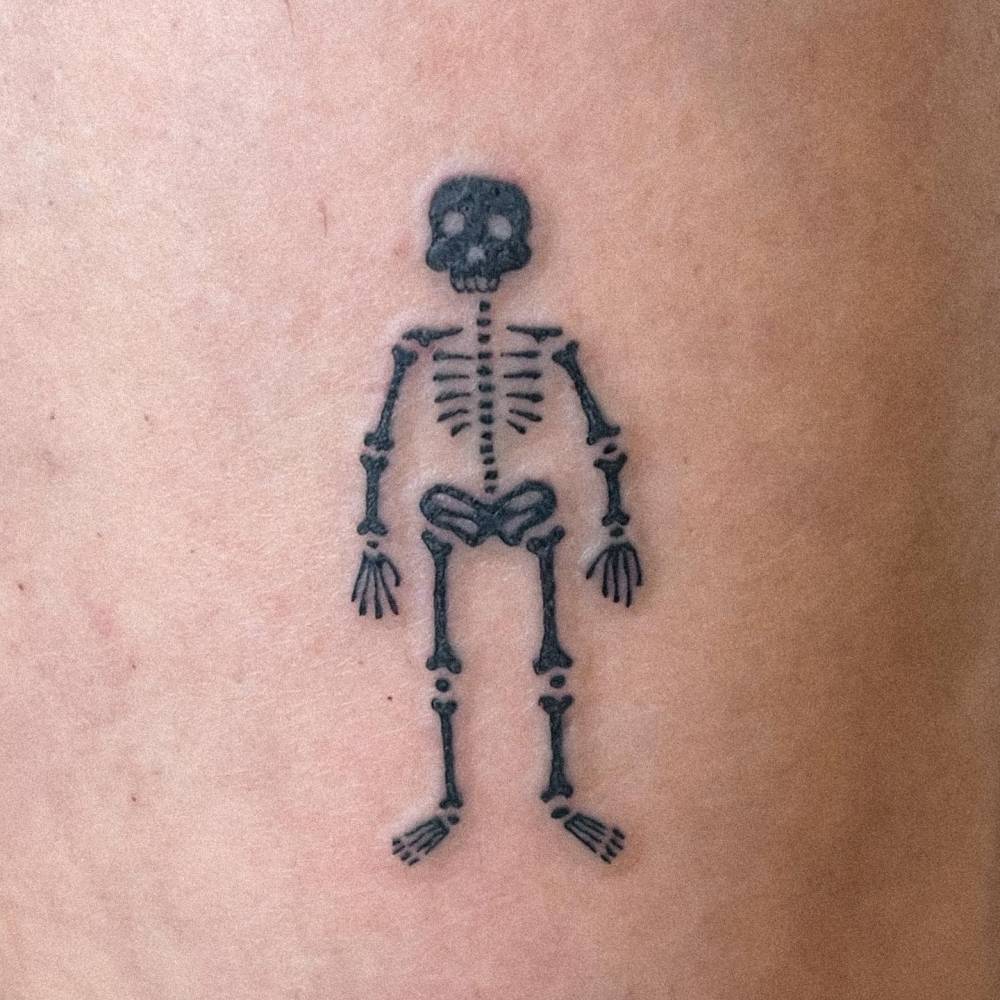 Little skeleton tattoo located on the shin.