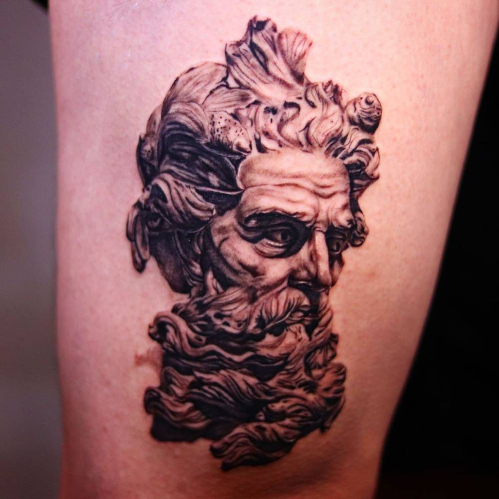 'Bust of Neptune' tattoo located on the thigh, black and grey style.
