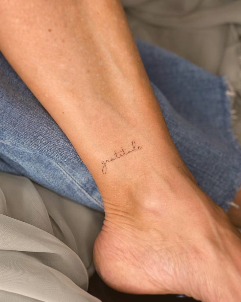 Handwritten font word "gratitude" located on the ankle.