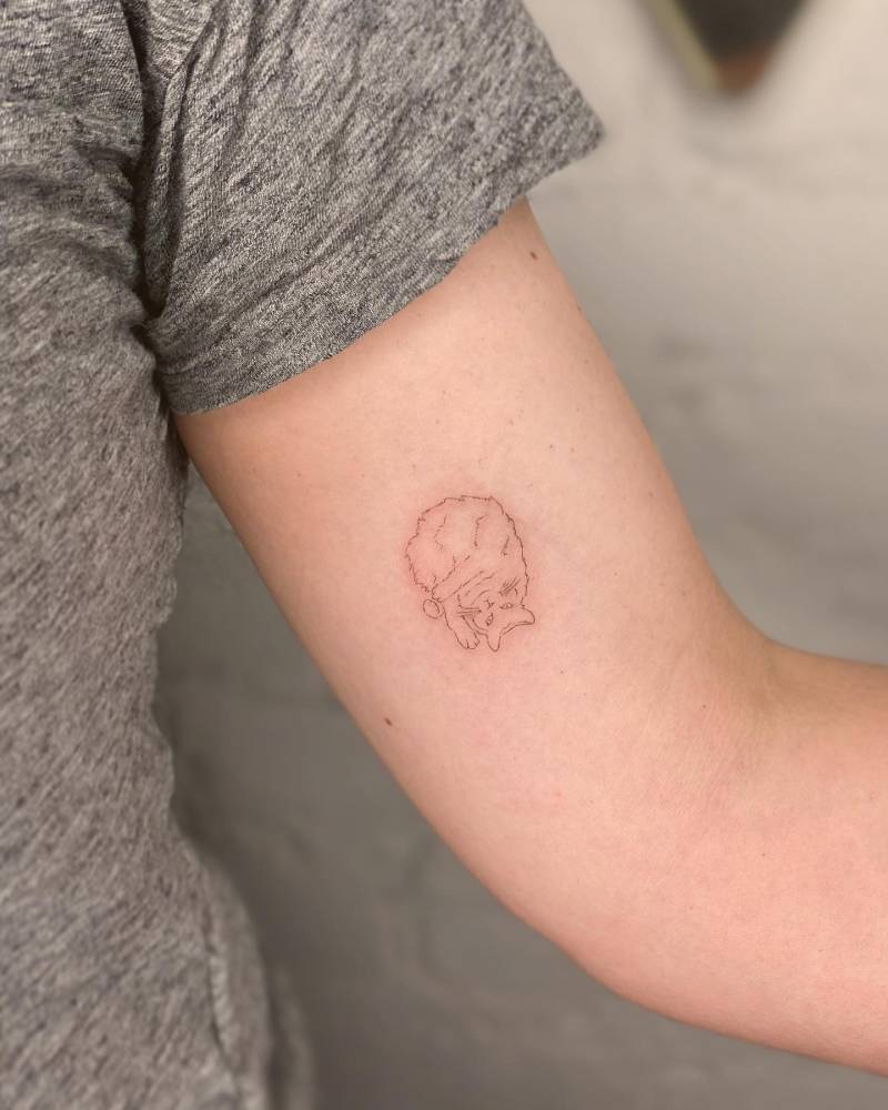 Little fine line style cat tattoo placed on the inner arm.