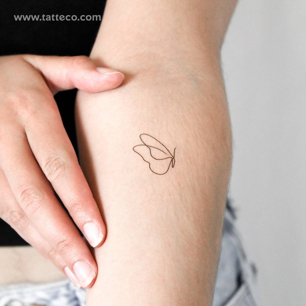 Continuous line butterfly temporary tattoo located on the inner forearm.