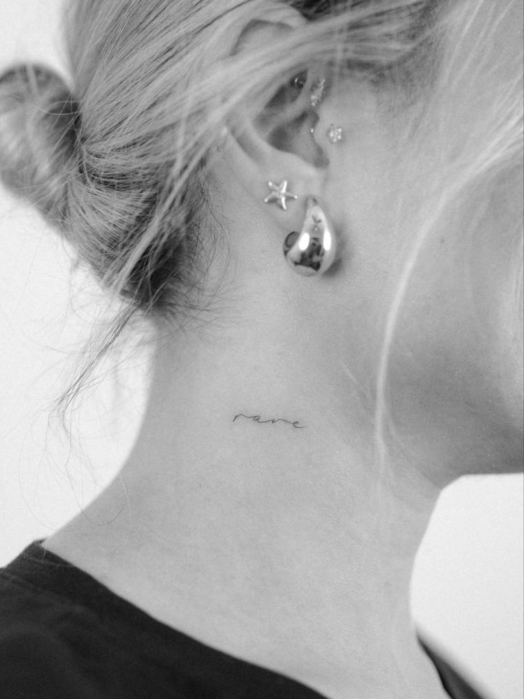 Lettering tattoo of the word "rare" placed on the neck.