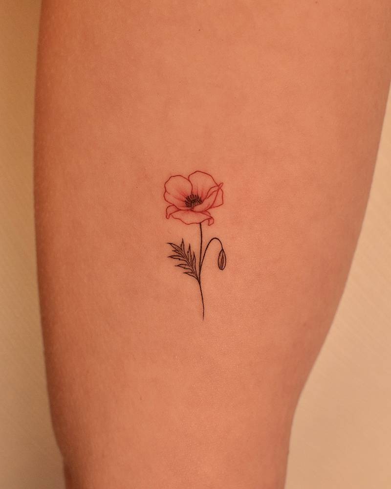 Little poppy flower tattoo located on the inner arm.