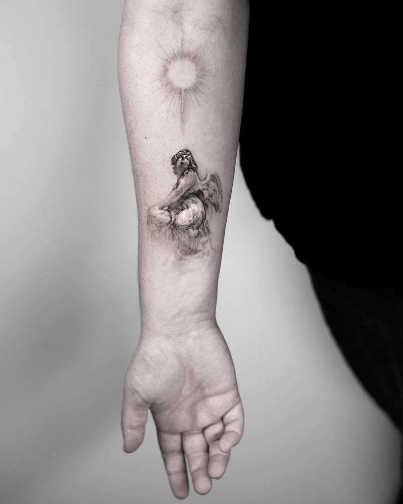 Micro-realistic angel tattoo located on the inner forearm.
