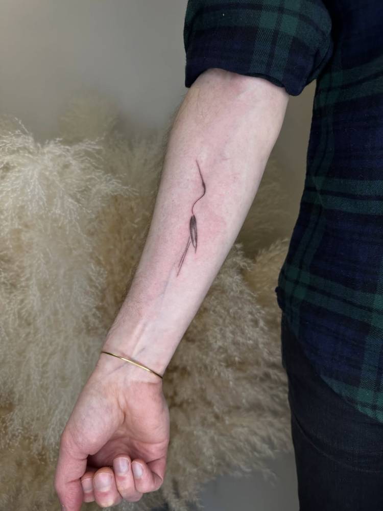 Minimalistic style crane tattoo located on the inner forearm.