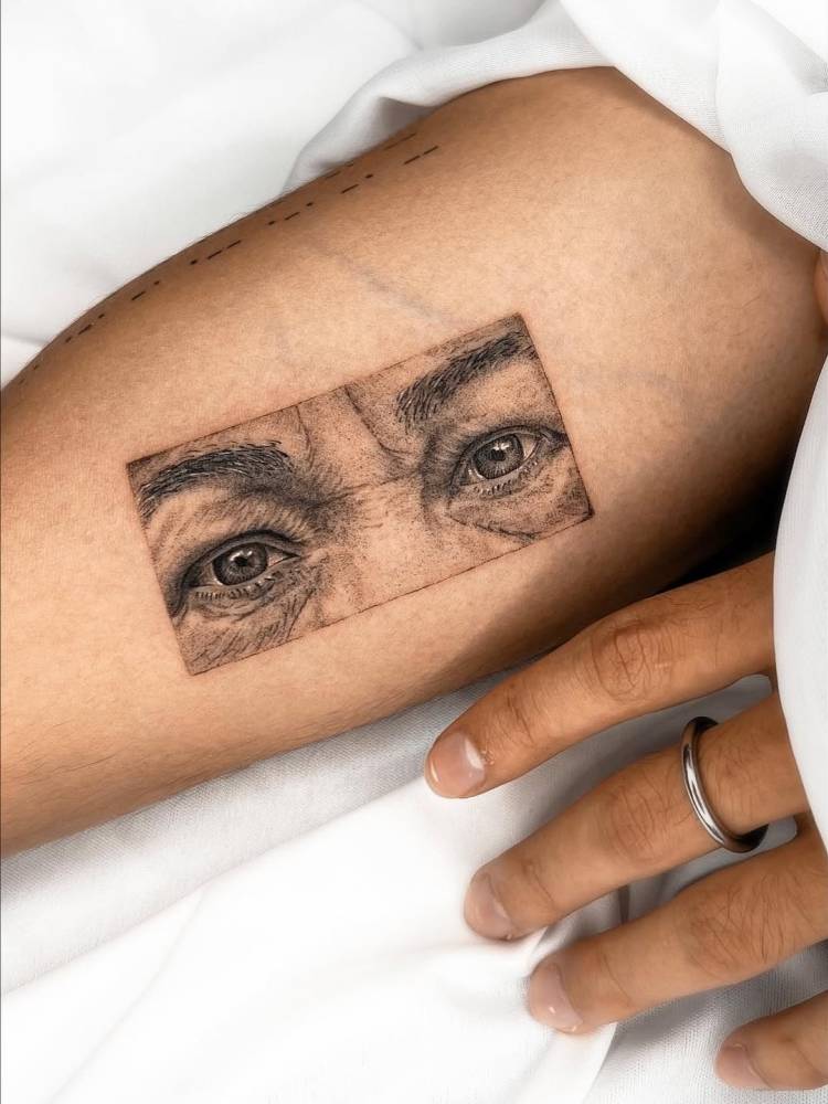 Eyes tattoo in micro-realistic style located on the inner arm.