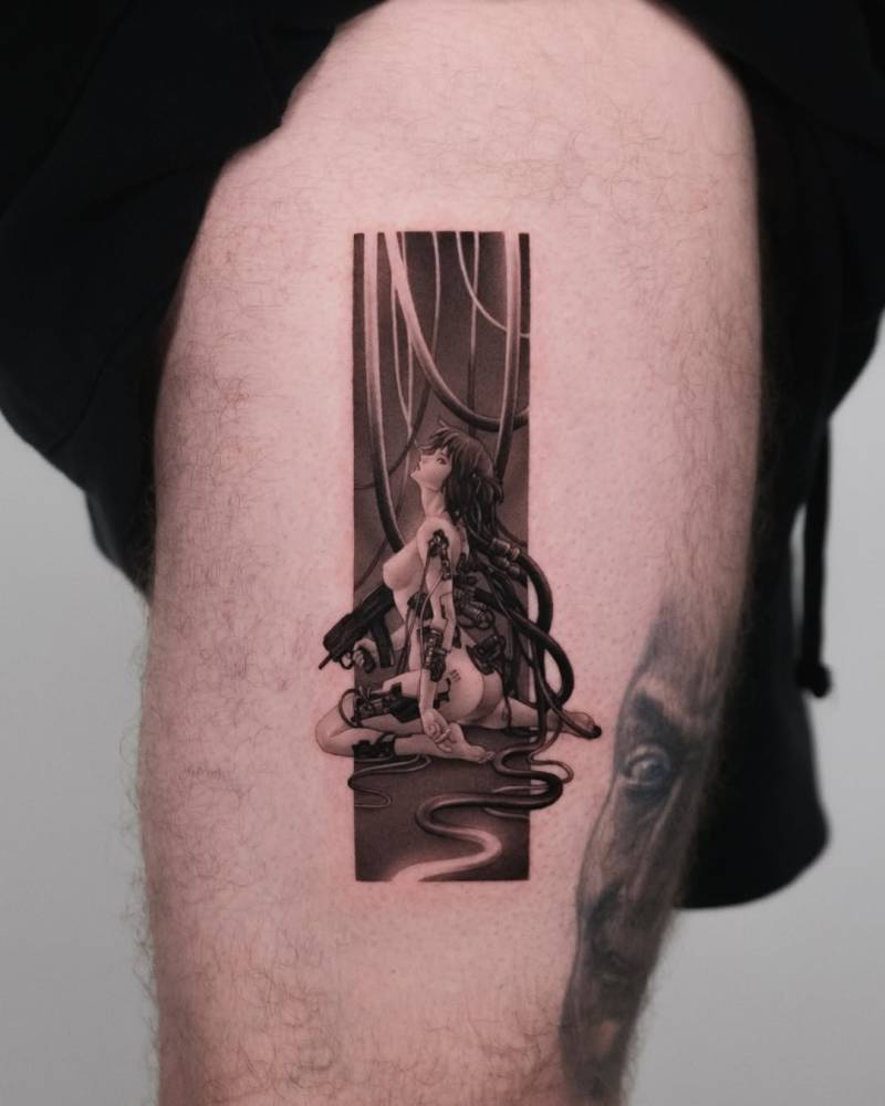 Ghost in the shell tattoo located on the thigh.