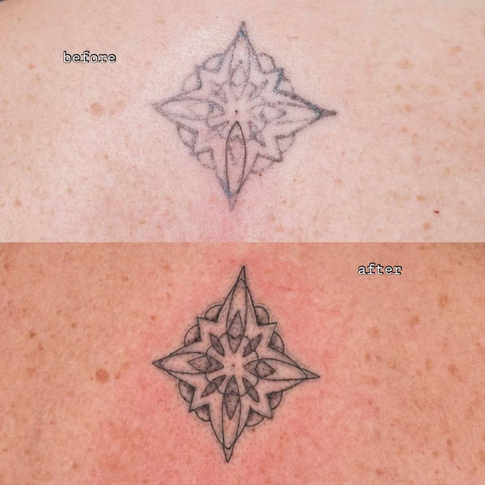 Touch up ornamental tattoo located on the back.