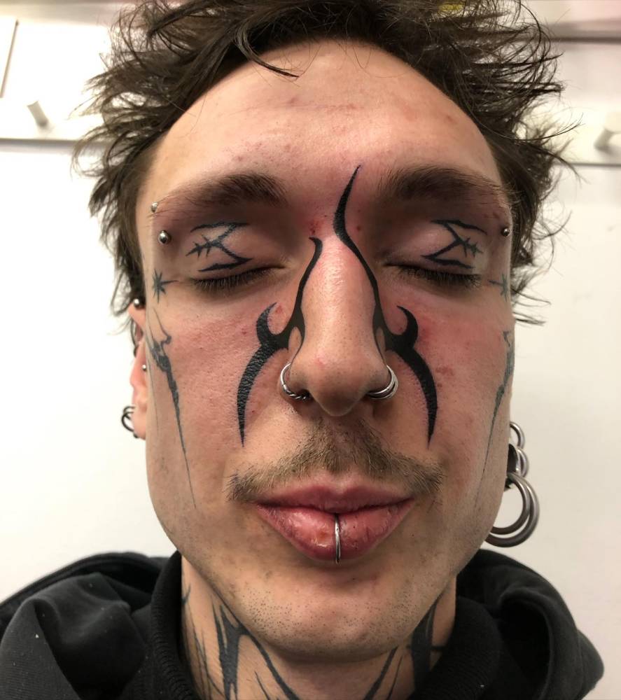 Tribal style tattoo located on the face.