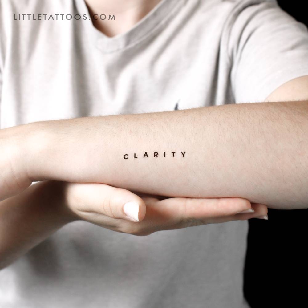 Word 'clarity' temporary lettering tattoo done on the wrist.