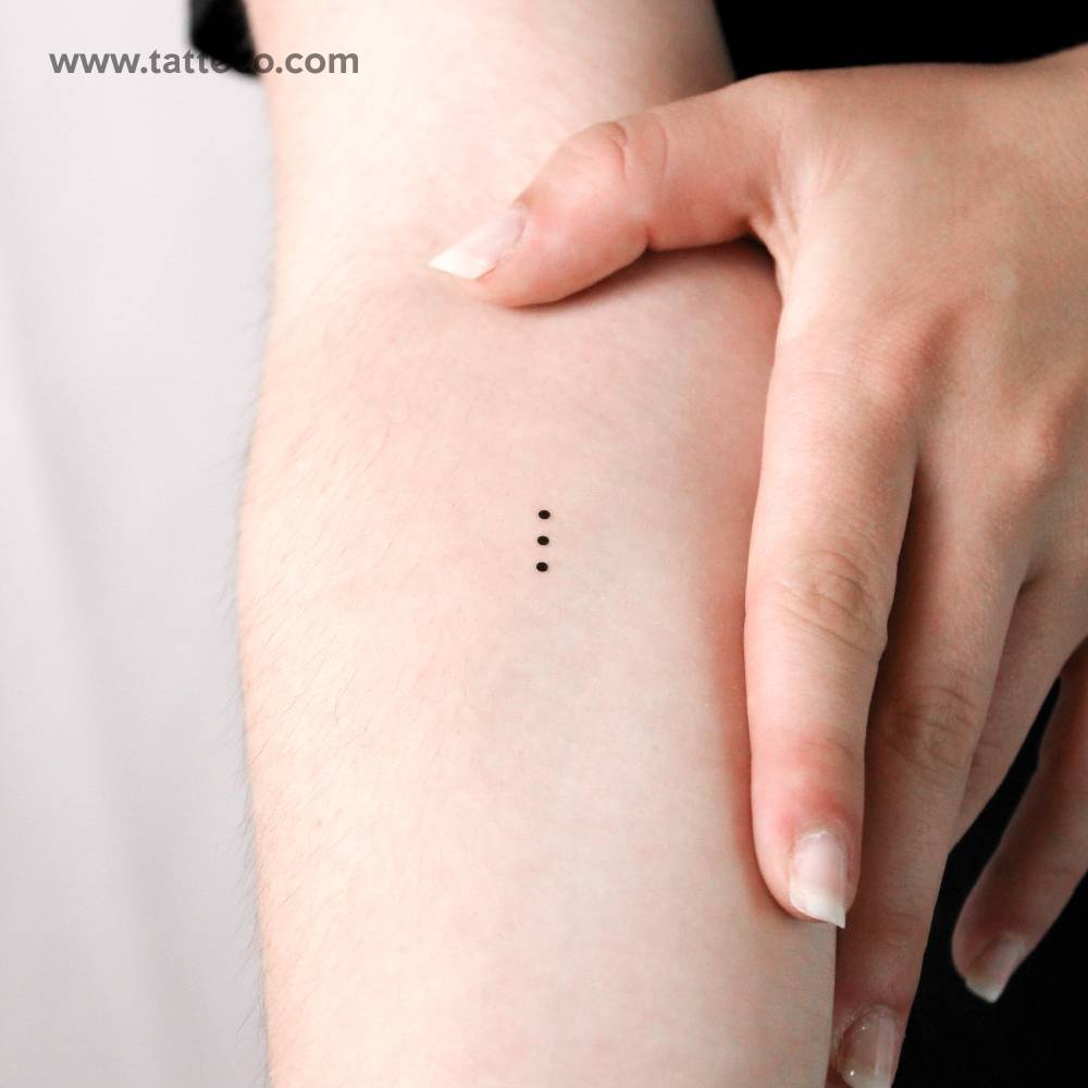 Three tiny dots temporary tattoo in minimalistic style.