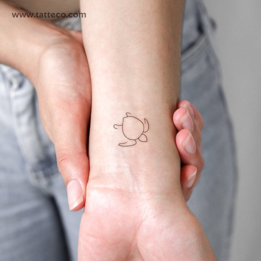 Minimalistic style turtle temporary tattoo located on the wrist.
