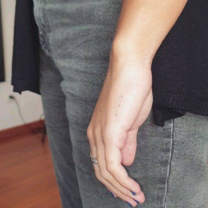 Minimalist dots tattoo on the hand.