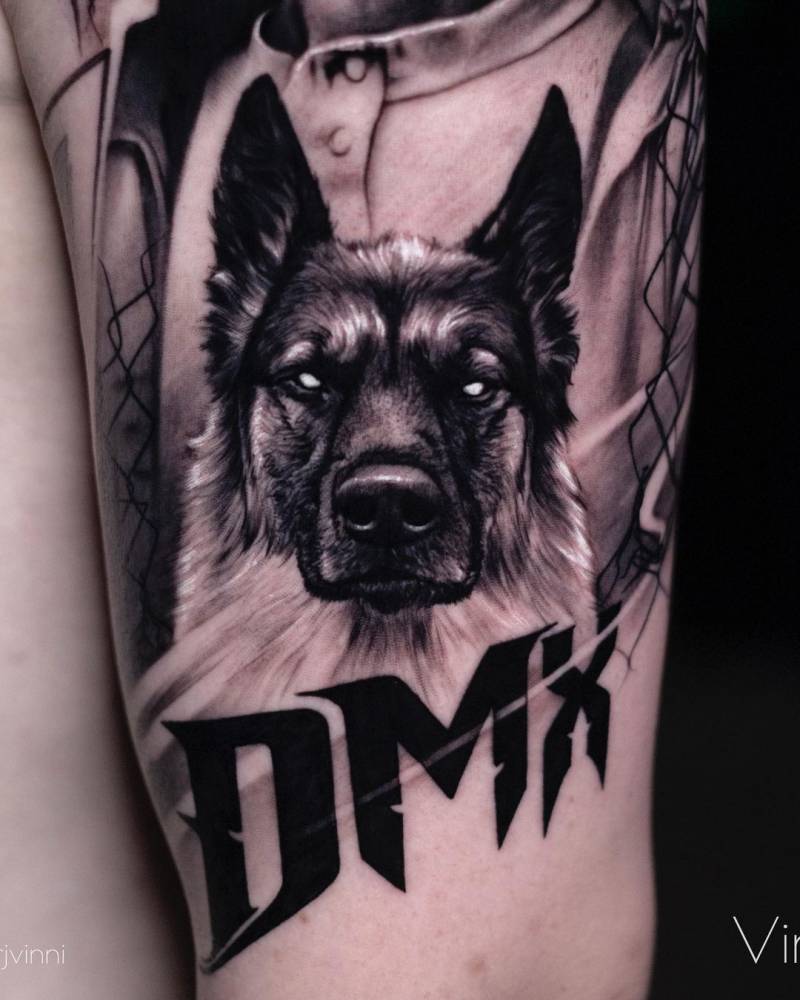 German Shepherd portrait tattoo located on the upper arm.