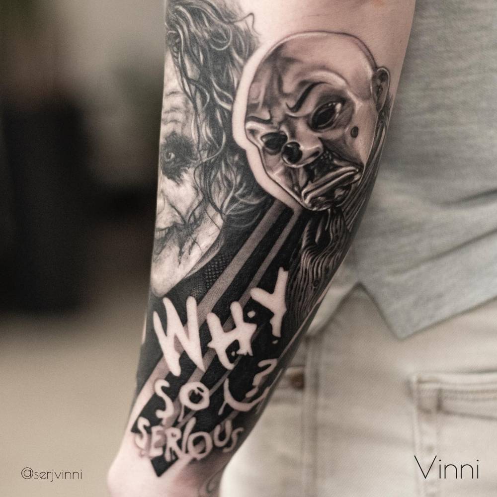 Black and grey The Joker tattoo located on the forearm.