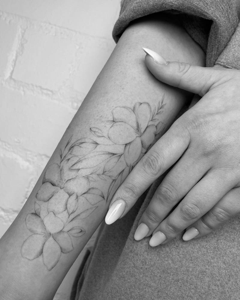 Cherry blossom tattoo located on the inner forearm.