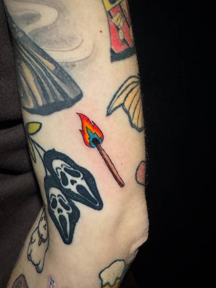 Hand poked matchstick gap filler tattoo done on the upper arm.