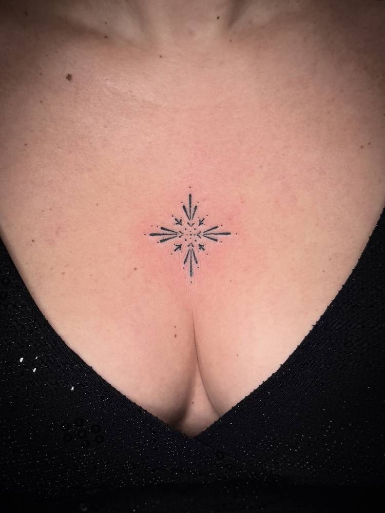 Hand poked ornamental tattoo done on the sternum.