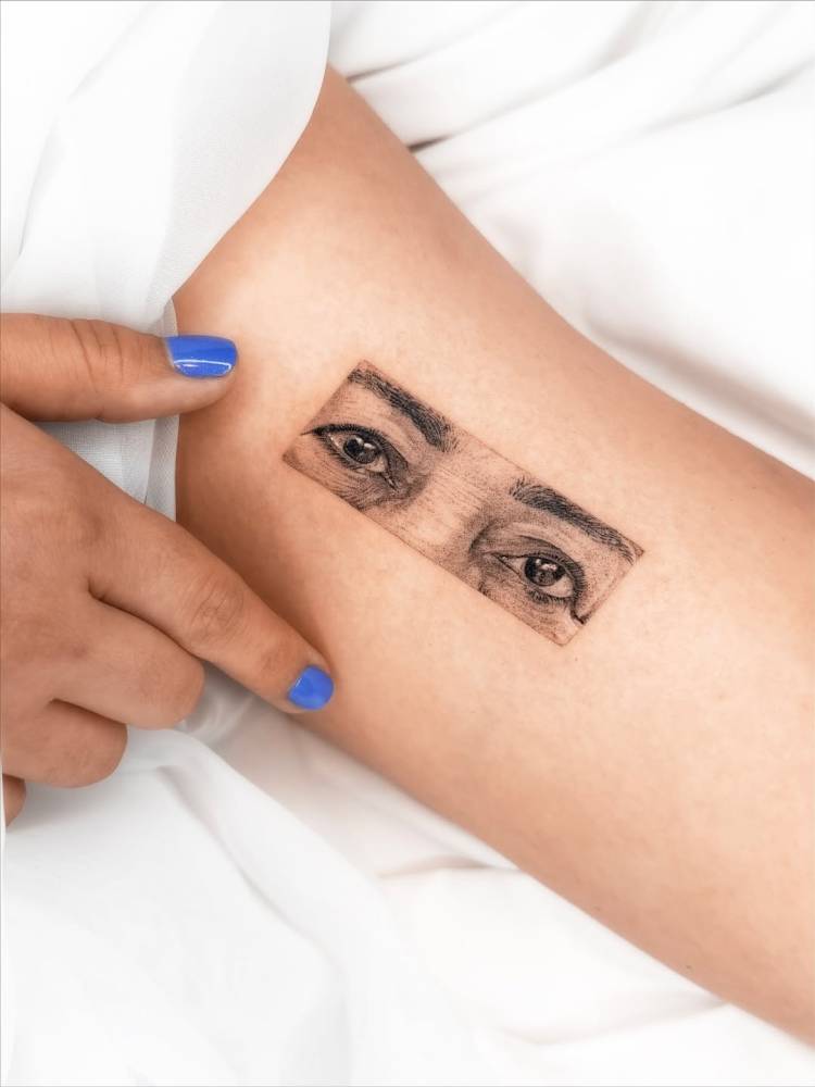 Eyes tattoo in micro-realistic style located on the inner arm.