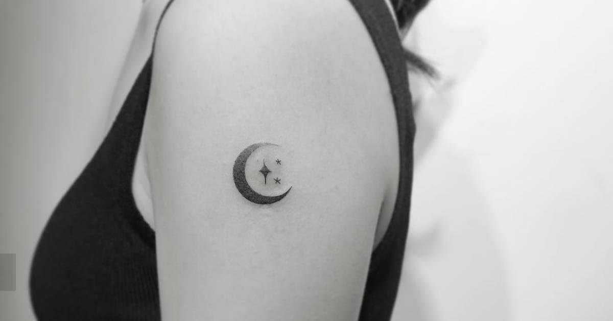 Spectrum moon and stars tattoo located on the upper
