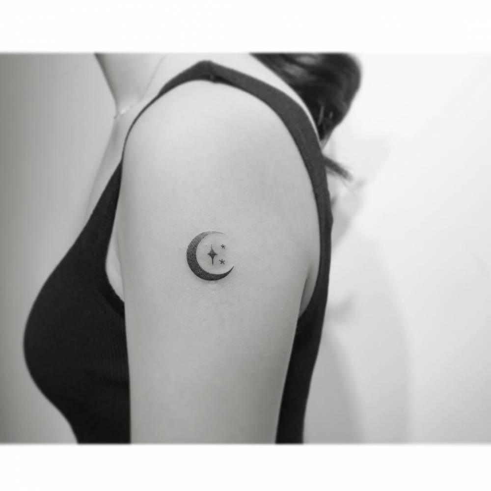 Spectrum moon and stars tattoo located on the upper arm.