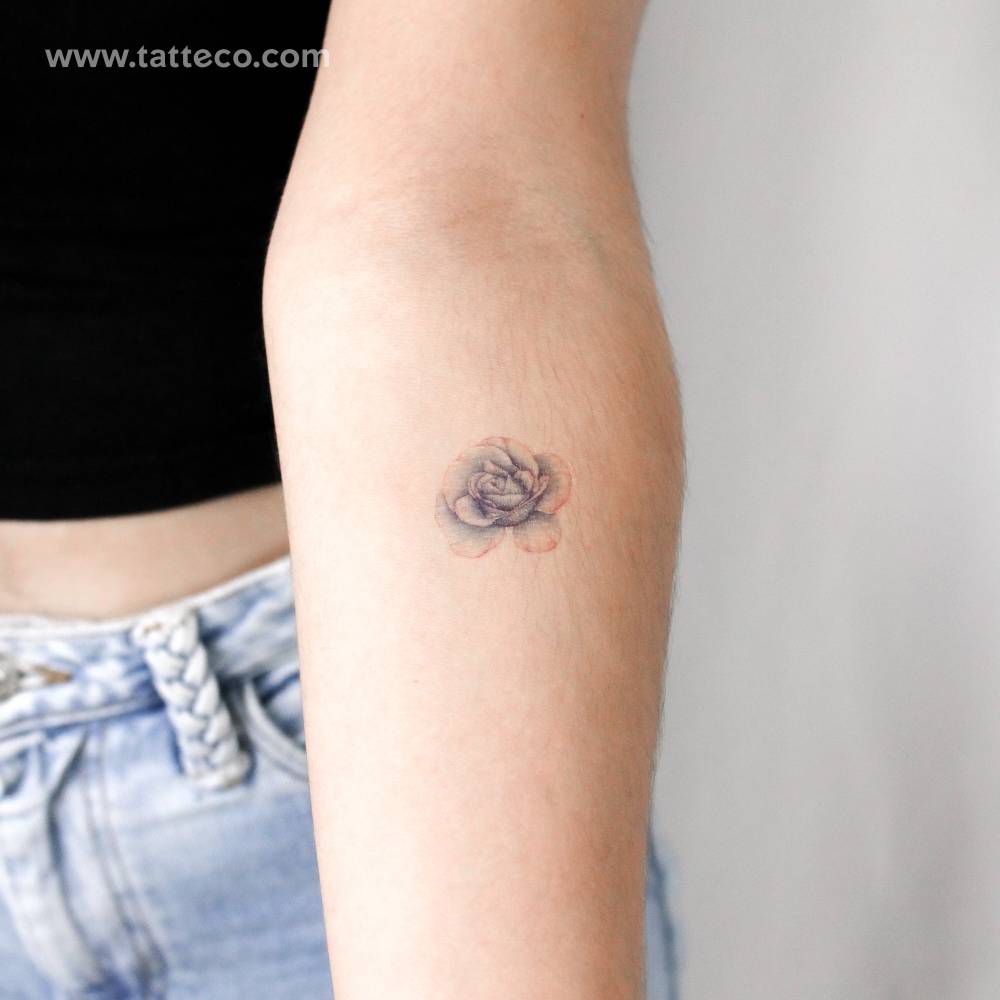 Illustrative style blue rose head temporary tattoo located on the inner forearm.