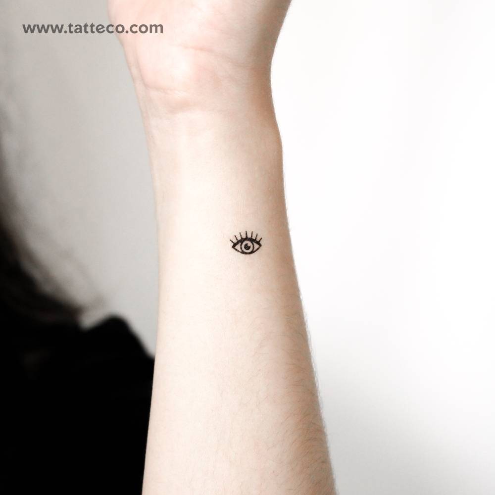 Tiny minimalistic eye temporary tattoo located on the wrist.