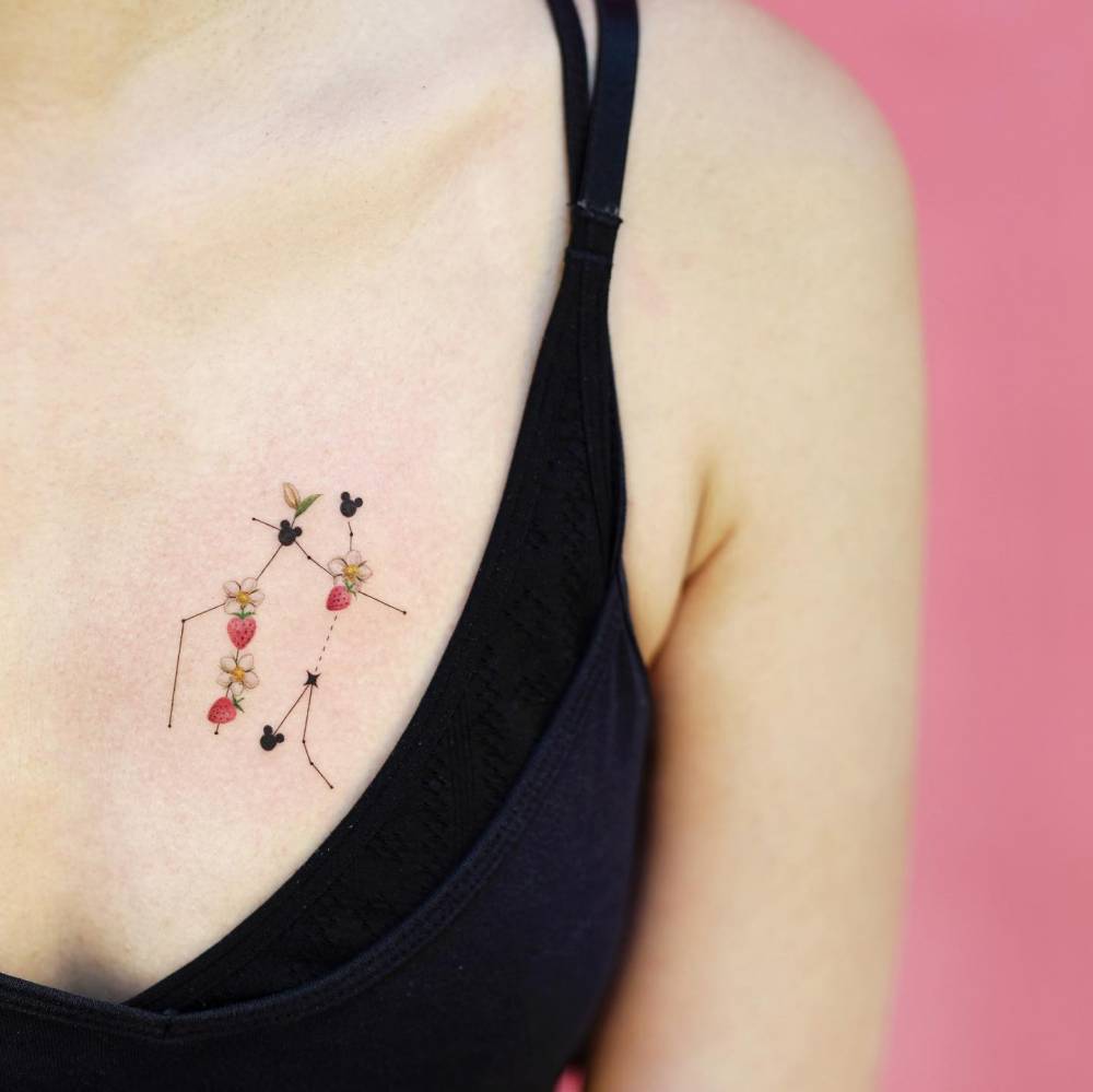 Gemini constellation tattoo placed on the chest, illustrative style.