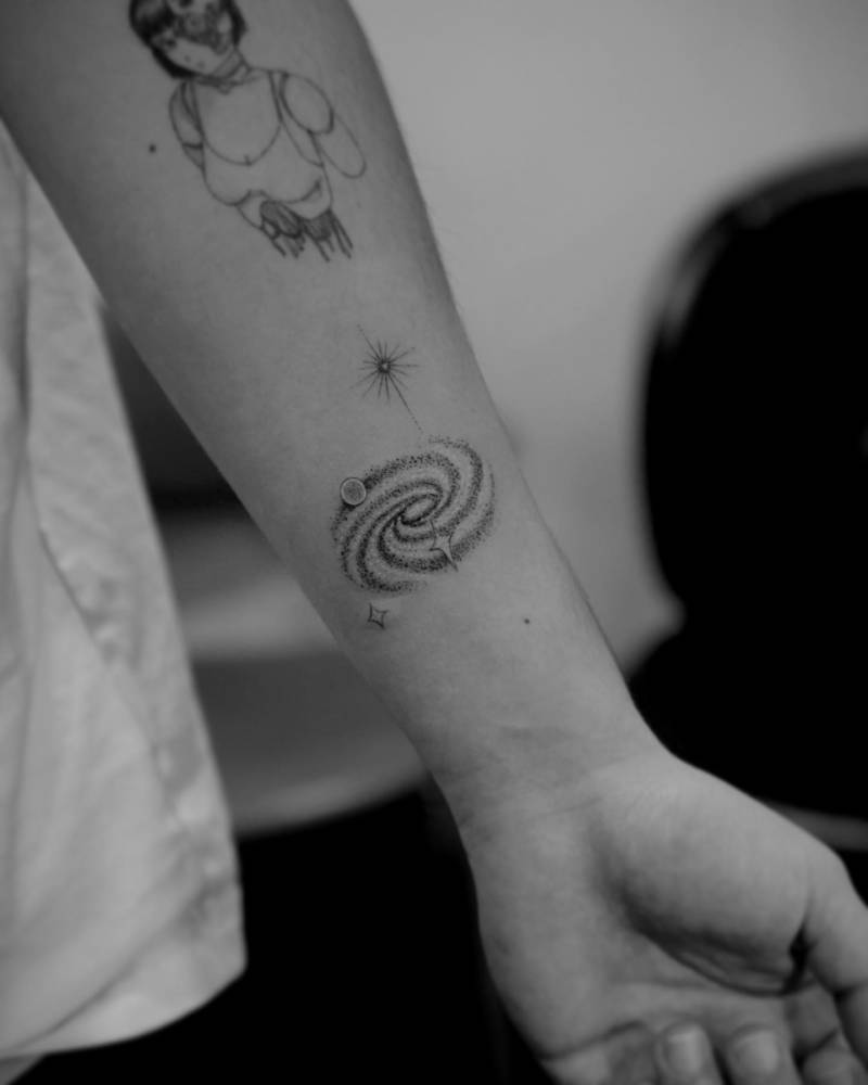 Single needle galaxy tattoo located on Basil Russo's wrist.