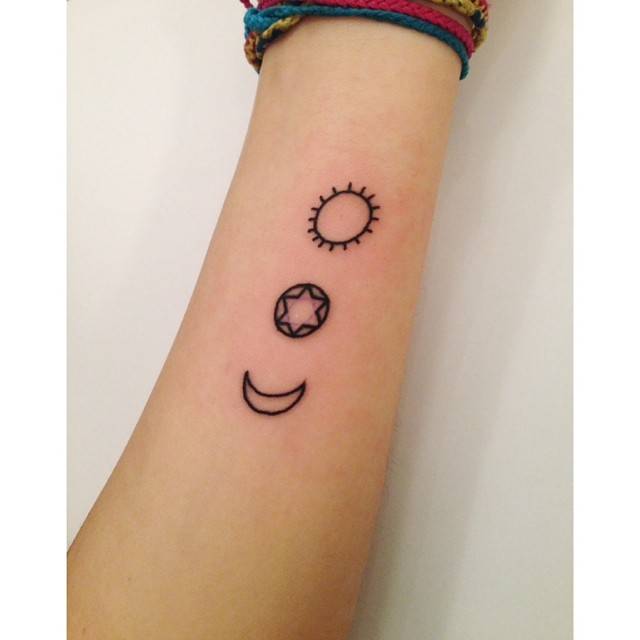Sun and moon tattoo located on the inner forearm.