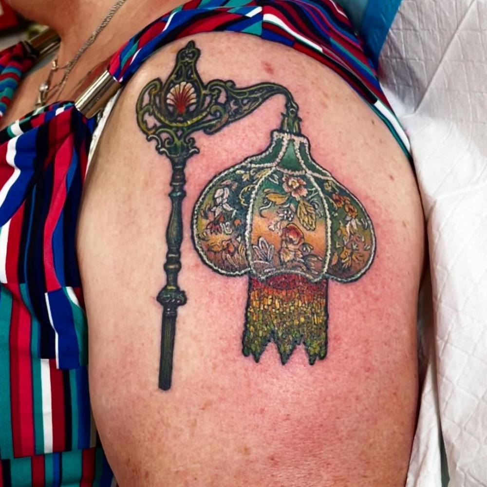 Lamp tattoo on the shoulder. Mostly healed some fresh.
