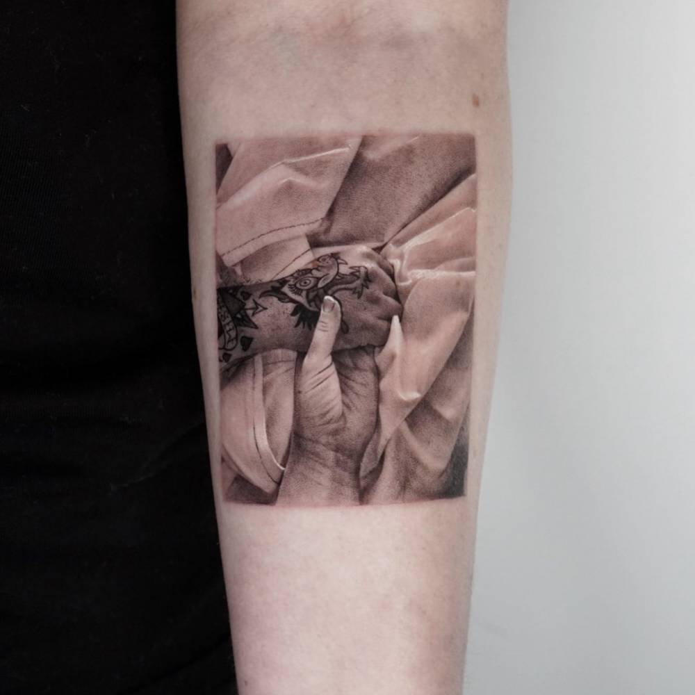 Memorial piece for her brother - Micro-realistic holding hands tattoo