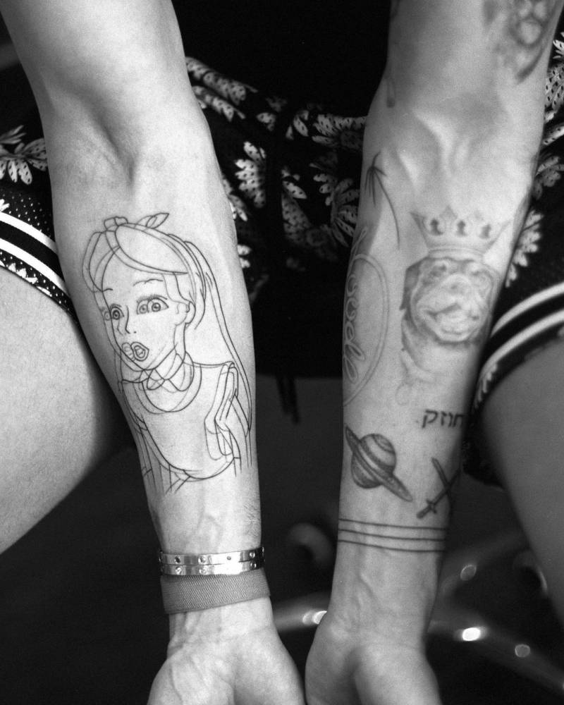 Disney's Alice anaglyph tattoo on the inner forearm